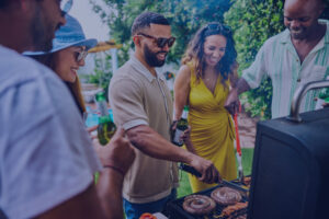 A Group of friends enjoying a barbecue and practicing Summer BBQ Food Safety